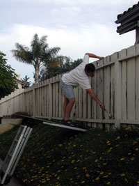 Keith painting a more difficult section of fence.