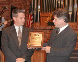Keith accepts award from Rev. Dale Suggs