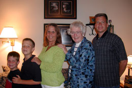 Doug, Brad, Judy, Aunt Betty, Keith in front of Judy's finally-framed art