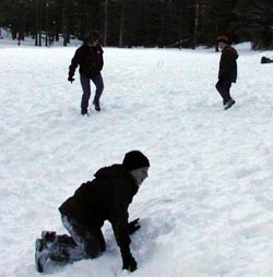 Kristi and Doug watch as Brad picks himself up out of snow
