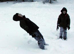Brad learns the first step in making a snow angel is to fall down backwards