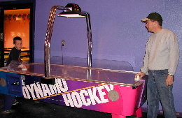 Dad schools Brad on the finer points of air hockey