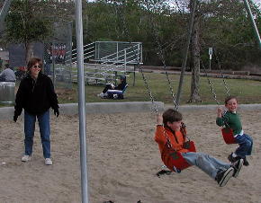 Kristi pushing Doug on cold, blustery day